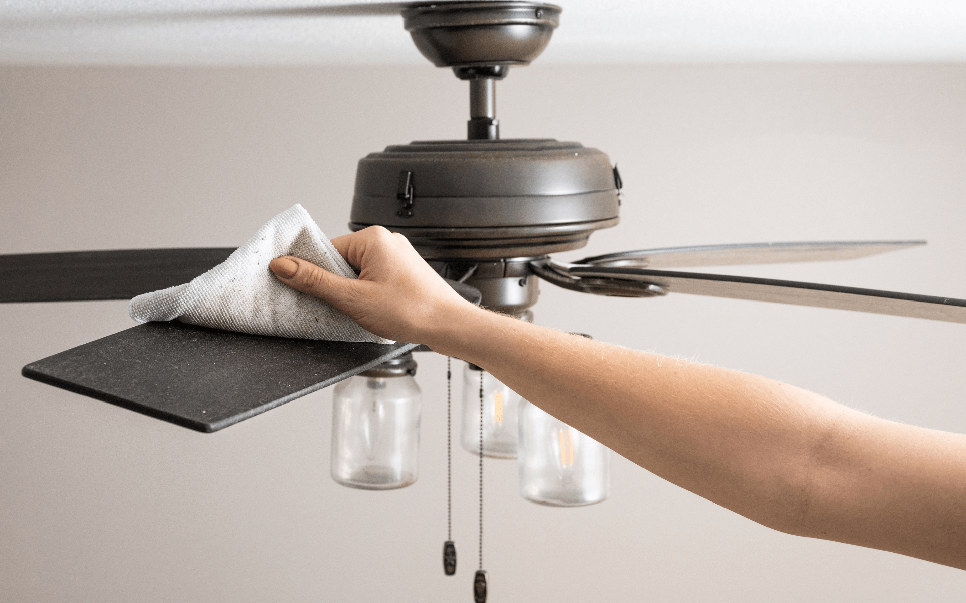 Dusting and wiping the fan blades.