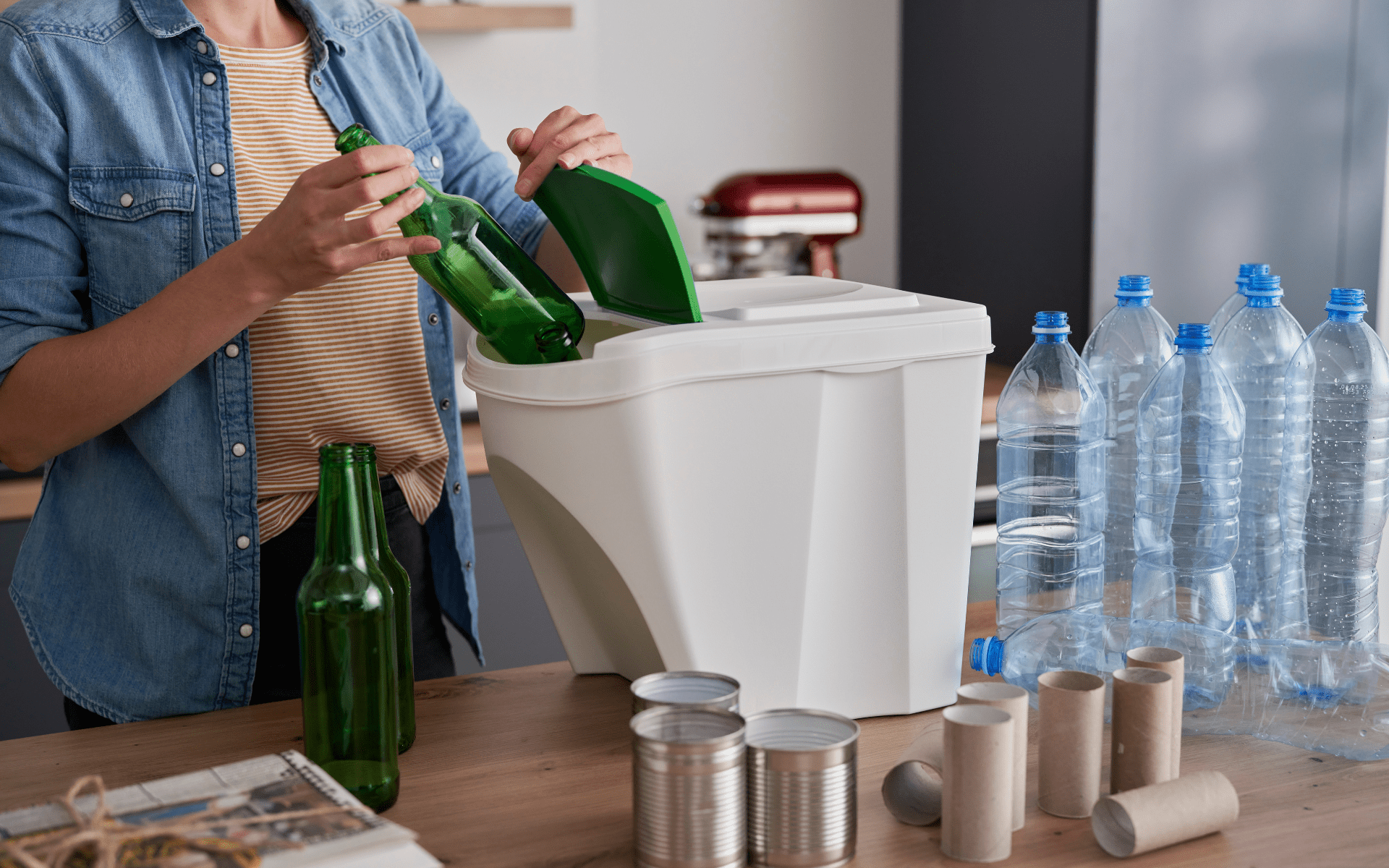 Sorting glass bottles, plastic bottles, cans, and cardboard rolls into bins.